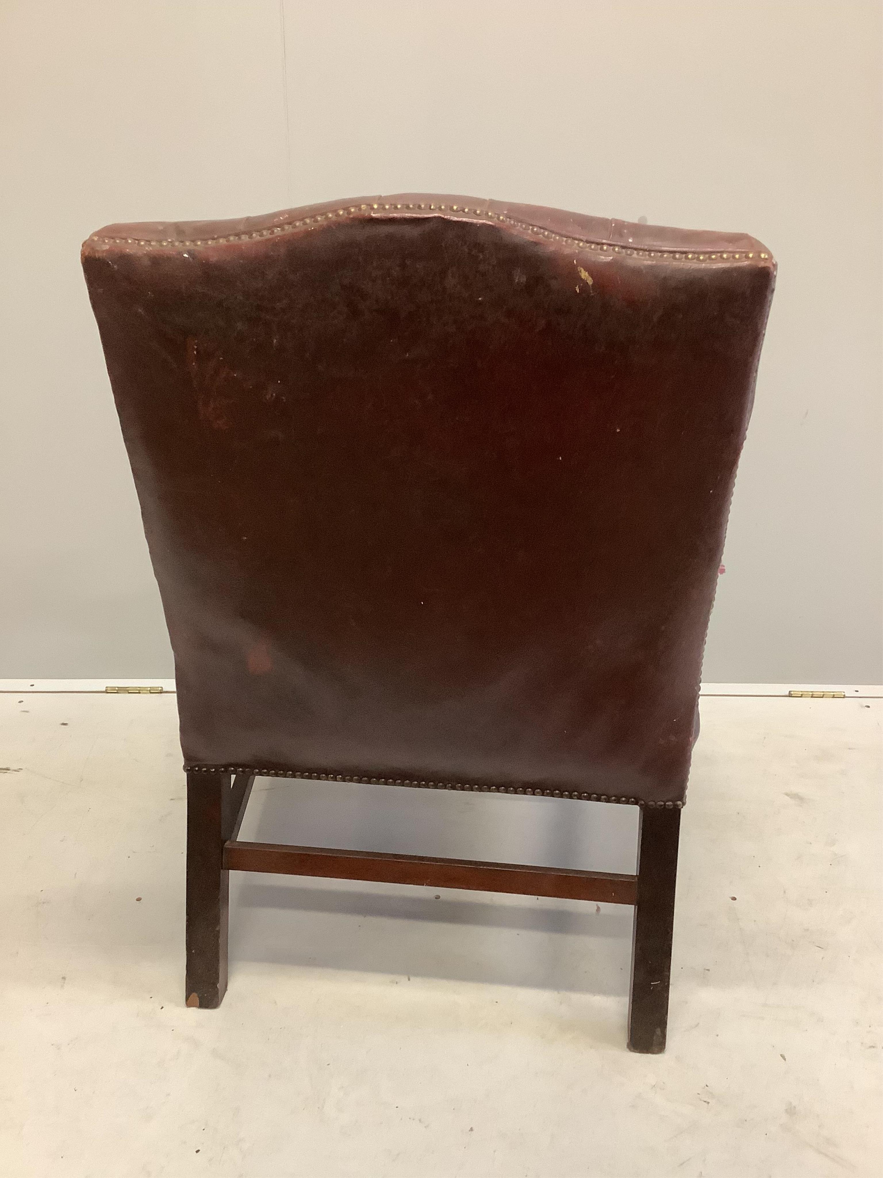 A George III style buttoned leather Gainsborough style chair, width 70cm, depth 61cm, height 94cm. Condition - fair